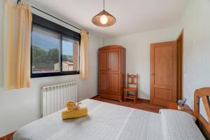 a bedroom with a bed with a wooden toy on it at Sueños de Guara Casa rural in Casbas de Huesca +31 photos