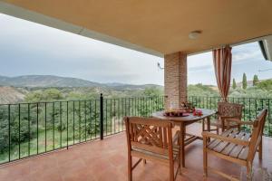 a dining room with a table and chairs on a balcony at Sueños de Guara Casa rural in Casbas de Huesca