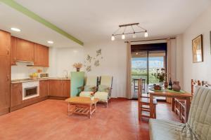 a kitchen and living room with a table and chairs at Sueños de Guara Casa rural in Casbas de Huesca