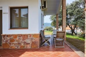 a patio with two chairs and a table on a house at La Aldeilla in Aldeaquemada