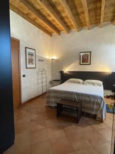 a bedroom with a bed and a table in it at La casa di Enea in Goito