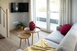 a living room with a couch and a table at Flutgold Dangast in Dangast