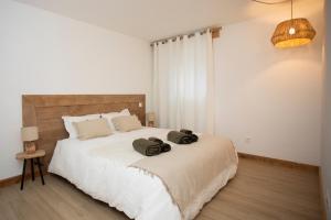 a bedroom with a large bed with two pillows on it at Appartement de charme - La Tour in La Tour
