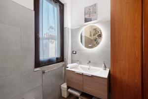 a bathroom with a sink and a mirror at Vigilio house in Calco +12 photos