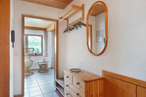 a bathroom with a wooden dresser and a mirror at Haus Marianne Dörflinger in Schluchsee +54 photos