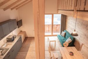 a kitchen and living room with a couch and a table at Peintnerhof Percha in Perca