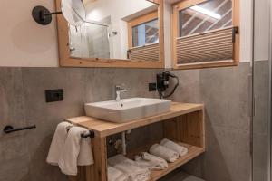 a bathroom with a sink and a mirror and towels at Peintnerhof Percha in Perca +103 photos