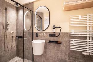 a bathroom with a shower and a mirror at Avia Living Elisabeth in Brunico +15 photos