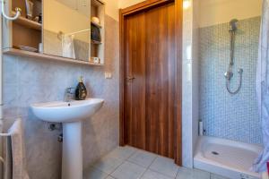 a bathroom with a sink and a toilet and a shower at Gadem House in Alghero +15 photos