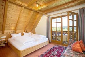 a bedroom with a bed in a room with a window at Ferienhaus Esche in Hinterzarten