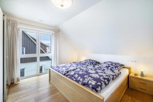 a bedroom with a bed and a large window at Ferienwohnung Schatz in Albstadt