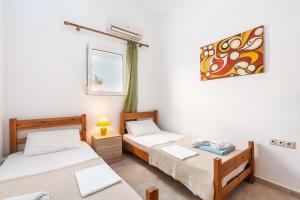 a room with two beds and a window at Beach Pearl in Lachania