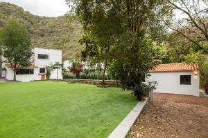 a large lawn in front of a house at Finca Los Tilos Moya in Moya