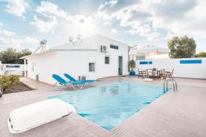 a villa with a swimming pool and a house at Beach Pearl in Lachania