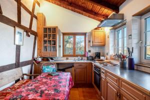 a kitchen with wooden cabinets and a bench in it at Maison Fleurie in Mitschdorf