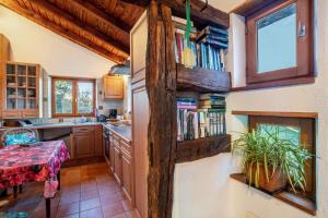 a kitchen with a book shelf with books at Maison Fleurie in Mitschdorf +23 photos