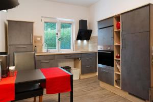 a kitchen with a table with a red blanket on it at Ferienwohnung Refugium Schönenberg in Sigmaringen