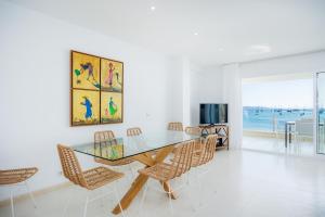 a dining room with a glass table and chairs at Catalina 2b tres dormitorios in Port de Pollensa
