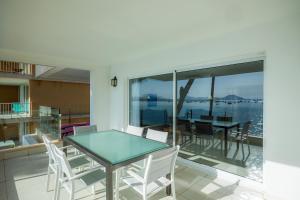a dining room with a glass table and white chairs at Catalina 2b tres dormitorios in Port de Pollensa