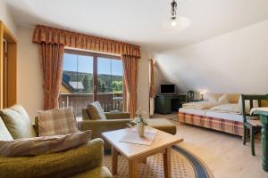 a living room with a couch and a bed at Pension Bergblick in Marienberg
