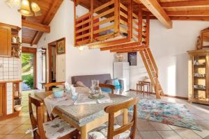 a kitchen and dining room with a table and a loft at Grace house holiday in San Fedele Intelvi