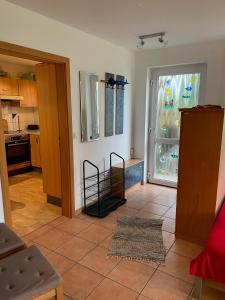 a living room with a door open to a kitchen at Ferienwohnung Ingrid Rautenberg in Krautheim