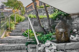 a stairway with a statue of a head at Haus Seeblick in Sipplingen