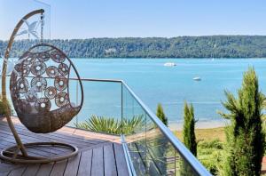 a balcony with a basket and a view of the water at Haus Seeblick in Sipplingen +5 photos