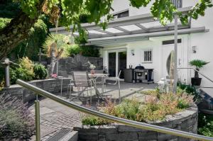 a patio with a table and chairs at Haus Seeblick in Sipplingen