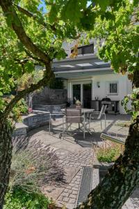 a patio with chairs and a table in front of a house at Haus Seeblick in Sipplingen