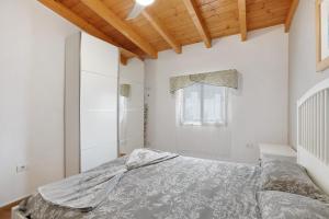 a bedroom with a bed and a wooden ceiling at Finca Keyfer in Vilaflor +25 photos