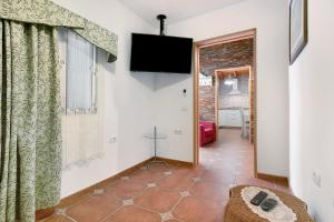 a living room with a flat screen tv on the wall at Finca Keyfer in Vilaflor