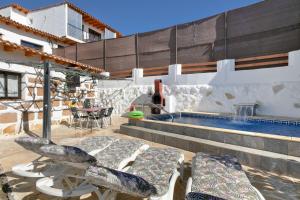 a patio with chairs and a swimming pool at Finca Keyfer in Vilaflor
