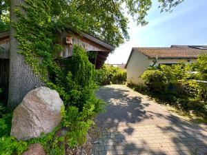 a brick path next to a house with a rock at Ferienhaus Ahaus in Ahaus