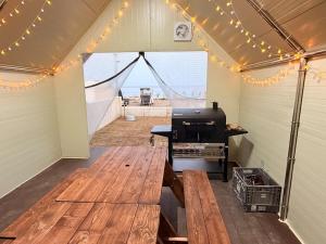a inside of a tent with a table and a grill at 포항 이가리 독채 풀빌라 엘리시안 풀빌라펜션 in Pohang