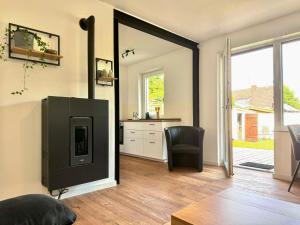 a living room with a tv and a chair at Ferienhaus Ahaus in Ahaus