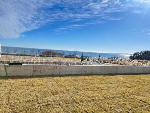 a retaining wall with a view of the ocean at 포항 이가리 독채 풀빌라 엘리시안 풀빌라펜션 in Pohang