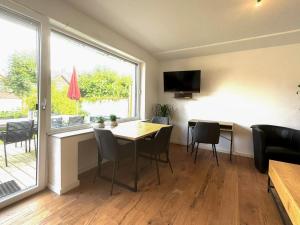 a dining room with a table and chairs and a window at Ferienhaus Ahaus in Ahaus