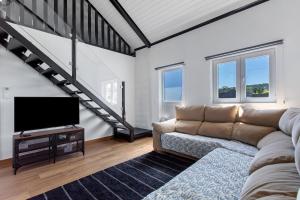 a living room with a couch and a flat screen tv at Casa do Canudo in Marinha Grande