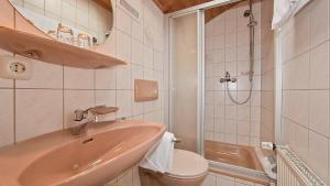 a bathroom with a sink and a toilet and a shower at Ferienwohnungen Weiß in Mittenwald +29 photos