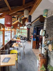 a restaurant with tables and chairs in a room at Hikers & Bikers in Haripūr