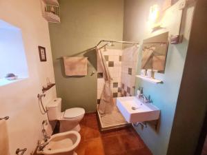 a bathroom with a toilet and a sink at Casa do Avô António in Bensafrim