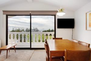 a dining room with a table and a large window at Casa Do Lenhador in Canhas