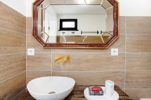 a bathroom with a sink and a mirror at Casa Do Lenhador in Canhas +17 photos