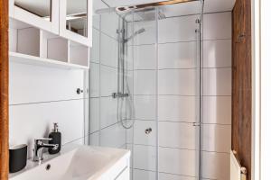a bathroom with a shower and a sink at Feichtenhäusl app 1 in Westendorf