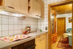 a kitchen with a stove and a counter top at Ferienwohnungen Landhaus Strell in Bad Griesbach