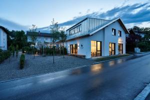 a white house on the side of a street at Alte Seifensiederei - Astrid in Bad Tölz +9 photos