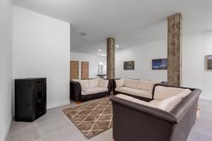 a living room with two couches and a tv at Finca Los Tilos Moya in Moya