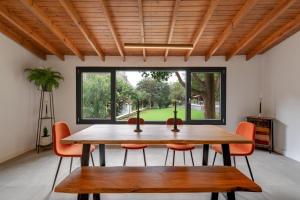 a dining room with a table and chairs and a large window at Finca Los Tilos Moya in Moya