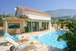 a villa with a swimming pool and a house at Villa Petalida Ideales Resort in Kefallonia
